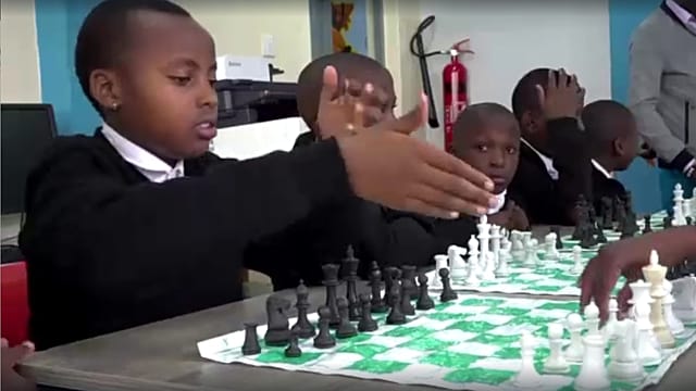 Kenyan children learn to play chess on sets made using plastic waste