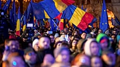 People wave Romanian and European Union flags during a pro-European rally ahead of the country's Dec. 8 runoff presidential elections in Bucharest, Romania, Thursday, Dec. 5, 