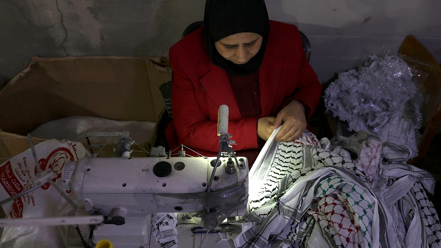 فلسطينية تقوم بتطريز الكوفية الفلسطينية في مدينة الخليل