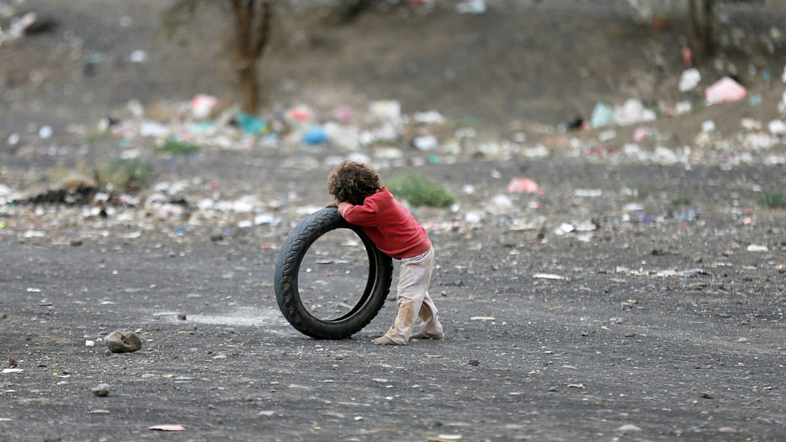 Boy leans on a tyre at a camp for internally displaced people near Sanaa
