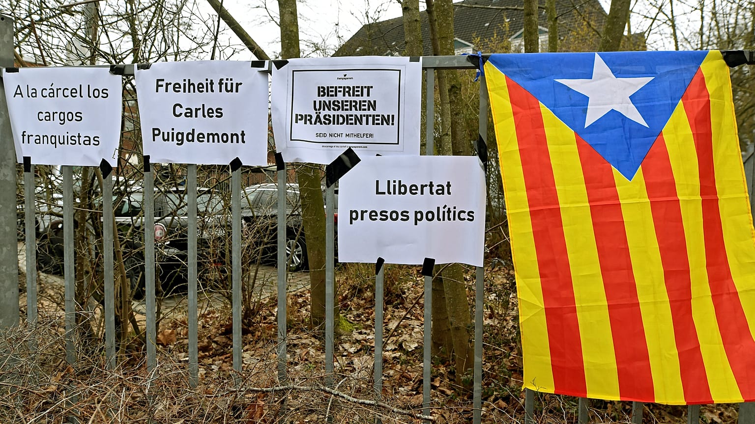 A Catalan separatist flag) is seen next to slogans in Neumuenster, Germany