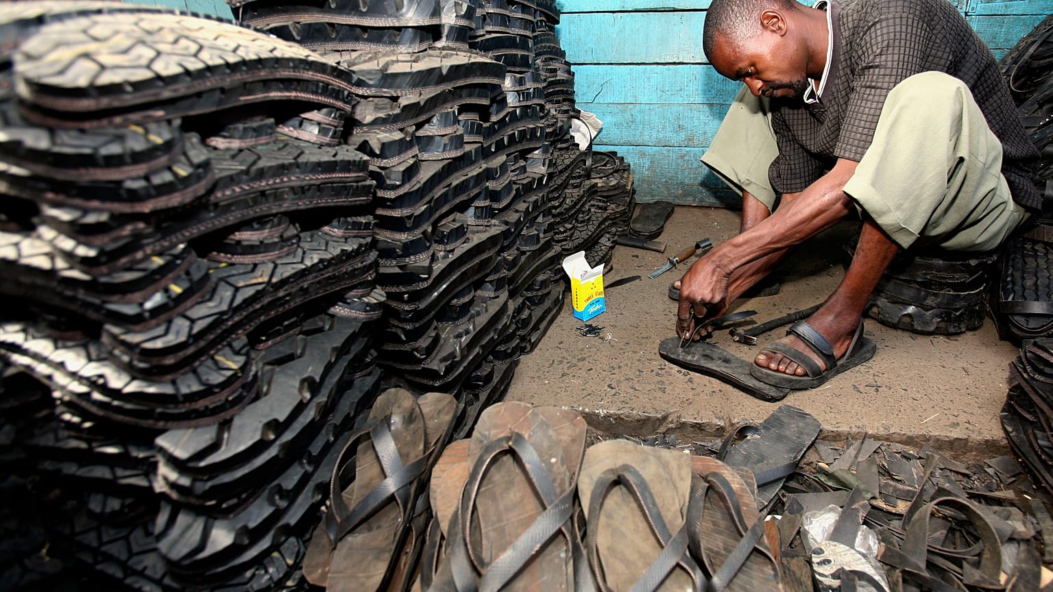 A man makes footwear from tyres in Ngara market, near Nairobi.