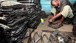 A man makes footwear from tyres in Ngara market, near Nairobi.