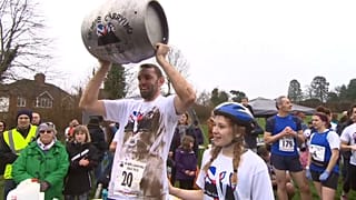 UK Wife-Carrying champion Chris Hepworth celebrates with Tanisha Prince.