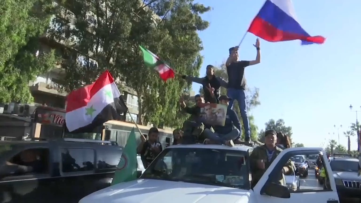 Syrians gather along the streets of Damascus to condemn the air strikes