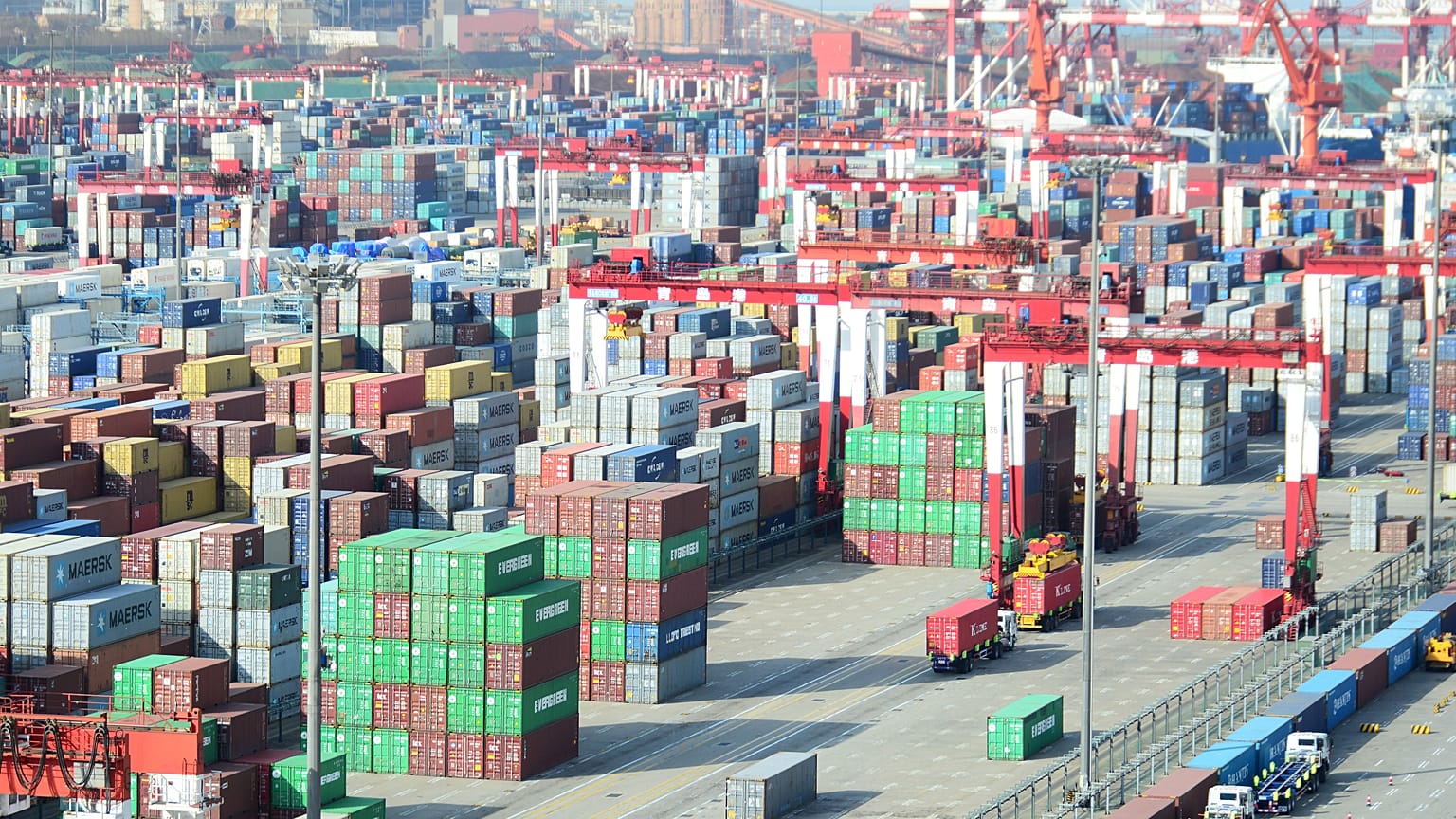 Shipping containers are seen piled up at a port in Qingdao