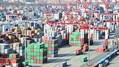 Shipping containers are seen piled up at a port in Qingdao