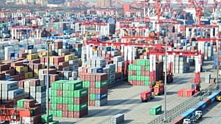 Shipping containers are seen piled up at a port in Qingdao