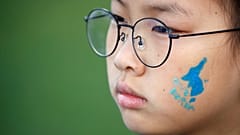 A blue silhouette of the Korean peninsula on childs face