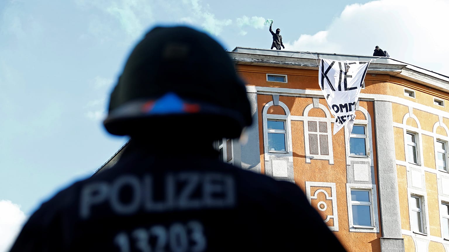 Police look an as protesters use flares ahead of May Day rallies in Berlin