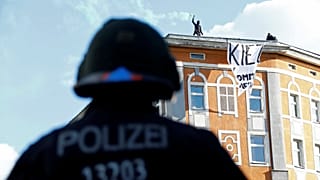 Police look an as protesters use flares ahead of May Day rallies in Berlin