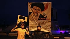 portraits of Shi'ite cleric Moqtada al-Sadr