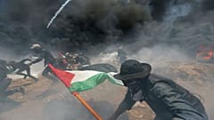 Palestinian demonstrators gather at the Israel-Gaza border