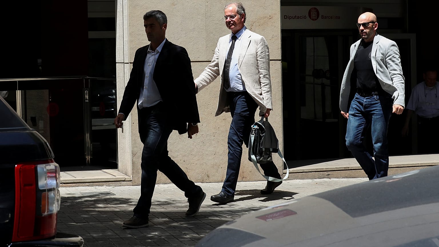 Investigating magistrate Joaquin Aguirre leaves one of the buildings 