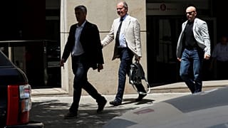Investigating magistrate Joaquin Aguirre leaves one of the buildings 