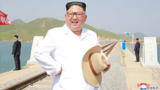 Kim Jong-un wears snappy white shirt, straw hat to inspect railway