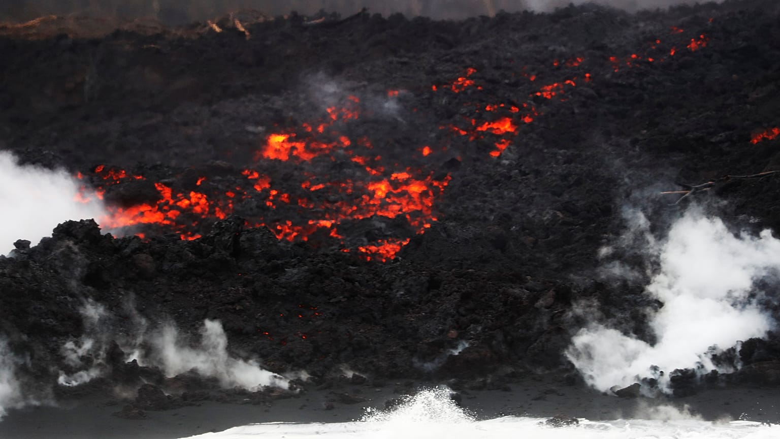 Lava pours into the ocean during the eruption of the Kilauea Volcano 