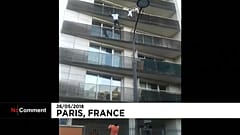 Malian migrant Mamoudou Gassama scales a building to save a young boy