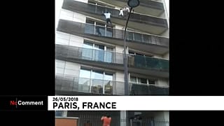 Malian migrant Mamoudou Gassama scales a building to save a young boy