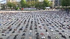 pairs of shoes representing lives lost in Mideast greet EU FMs
