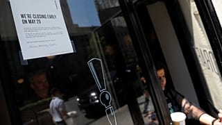 A sign in the window of a door of a Starbucks 