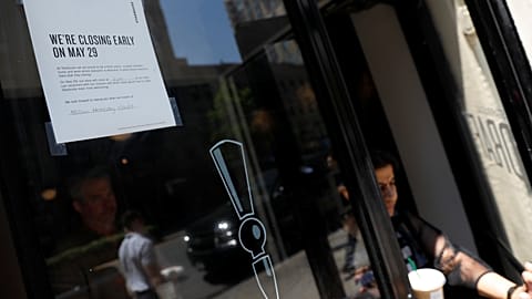 A sign in the window of a door of a Starbucks 