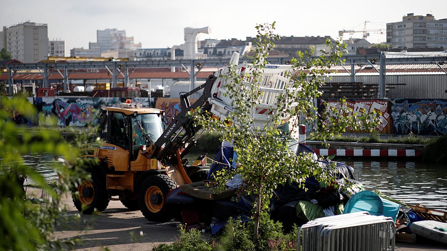 Police brought in bulldozers to help clear a migrant camp in Paris