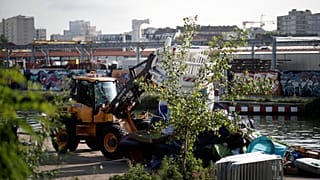 Police brought in bulldozers to help clear a migrant camp in Paris