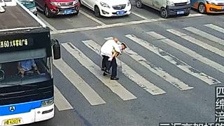 الشرطي حاملاً الرجل المسن على ظهره
