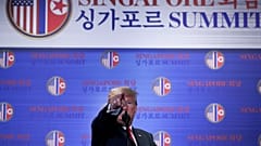 Trump points during a news conference after his summit with Kim Jong-un