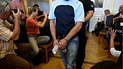 Four men, charged with the killing of 71 migrants