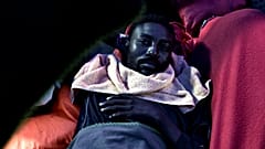 A migrant rests on the deck of MV Aquarius