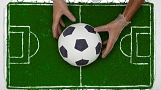 A pastry chef presents a football-shaped cake in Sochi, Russia, 16/06/2018