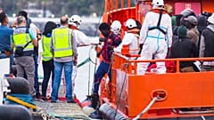 Migrants arrive aboard a Spanish maritime rescue boat