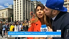 A fan grabs a TV reporter during  a live broadcast 