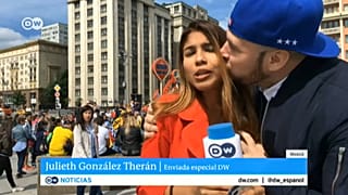A fan grabs a TV reporter during  a live broadcast 