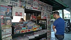Greek newspapers carrying news of the debt relief deal