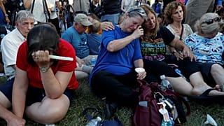 Tearful mourners at the vigil for the victims