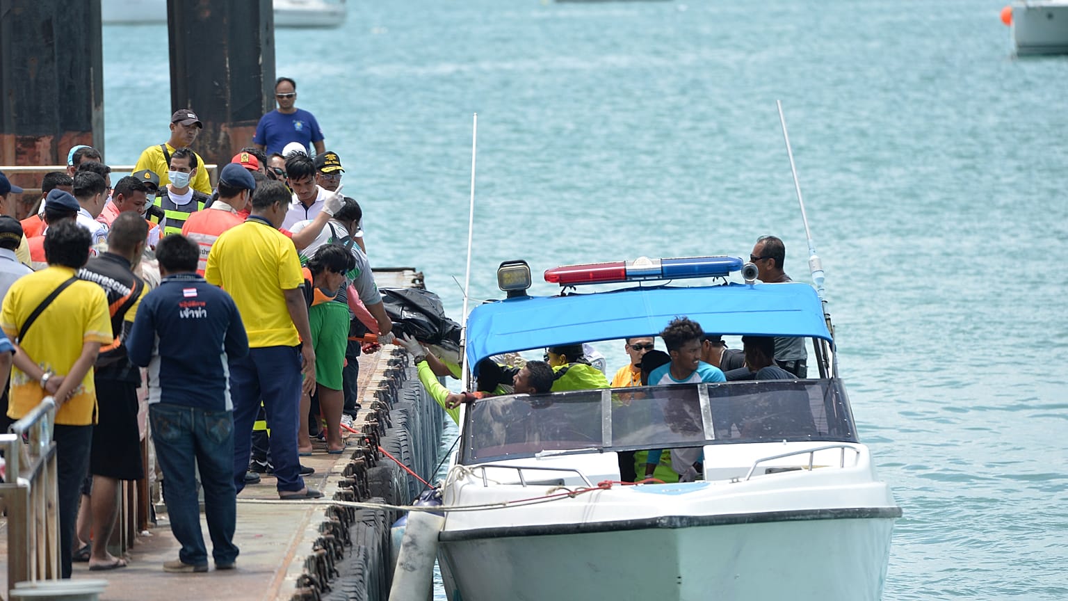 Rescue workers carry a body recovered from the scene