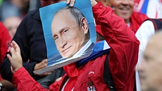 Where's Putin? Serbia fan holds a photo of the Russian leader at World Cup