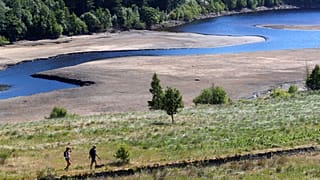 Des randonneurs passent devant un marais dans le Longdendale