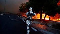 Un pompier en équipement lutte contre les incendies près d'Athènes, Grèce