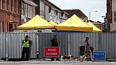 Police guard a sealed-off road