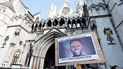 A poster supporting Tommy Robinson outside the High Court in London