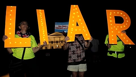 Protesters rally outside the White House in Washington on 16 July, 2018.