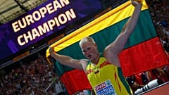 Andrius Gudžius of Lithuania celebrates winning a gold medal