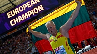 Andrius Gudžius of Lithuania celebrates winning a gold medal
