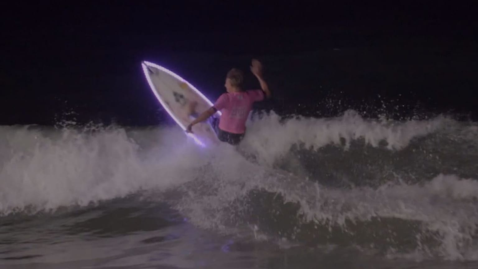 Watch: Surfers catch waves under moonlight 