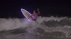 Watch: Surfers catch waves under moonlight 