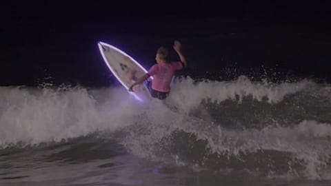 Watch: Surfers catch waves under moonlight 
